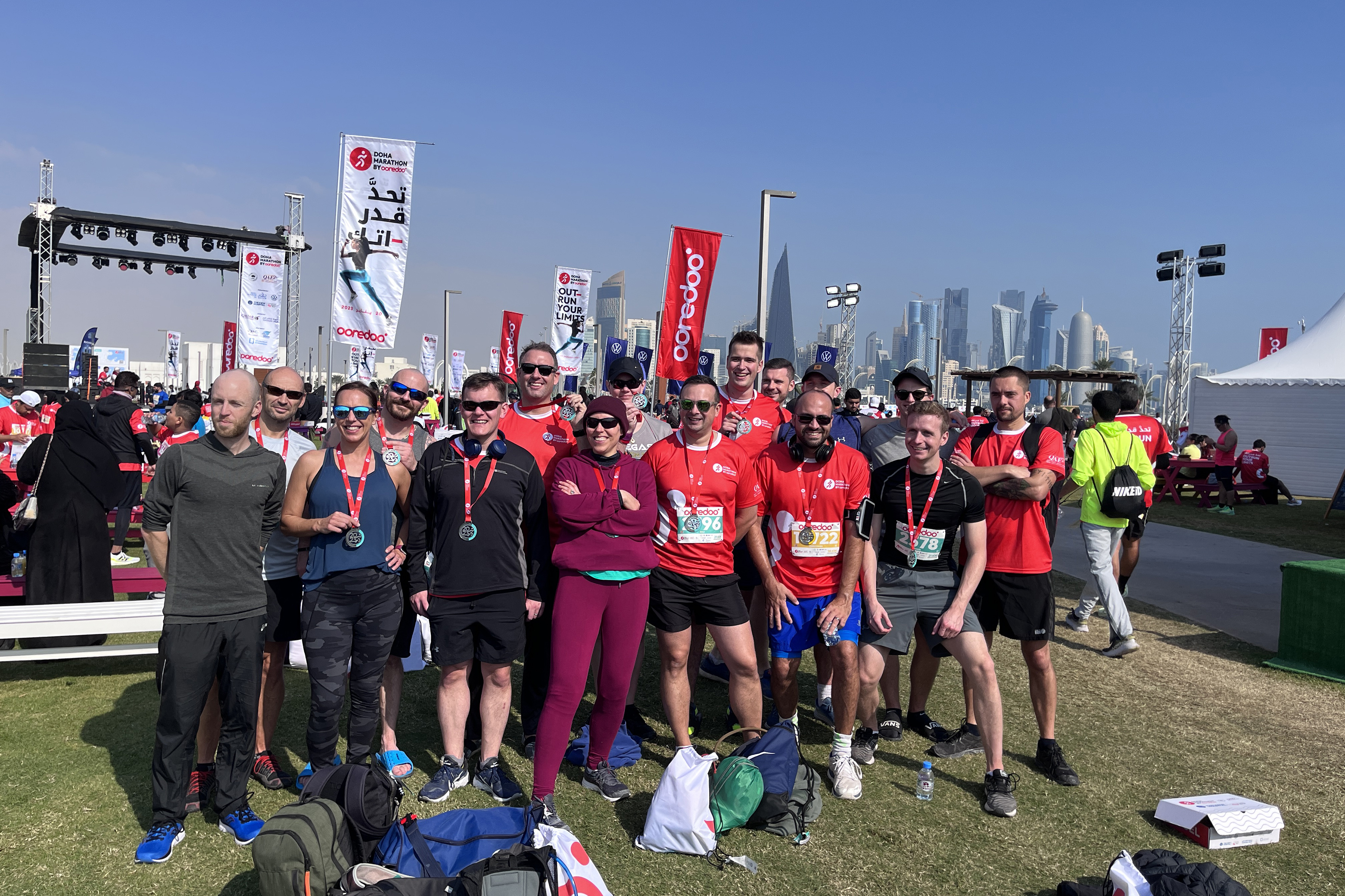 Image shows group photo of marathon competitors at the end of their race.